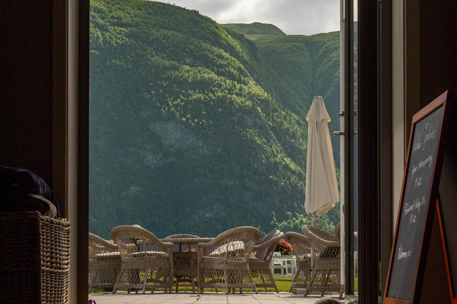 Utsikt fra restauranten mot hagen og fjellene ved Valldal Fjordhotell
