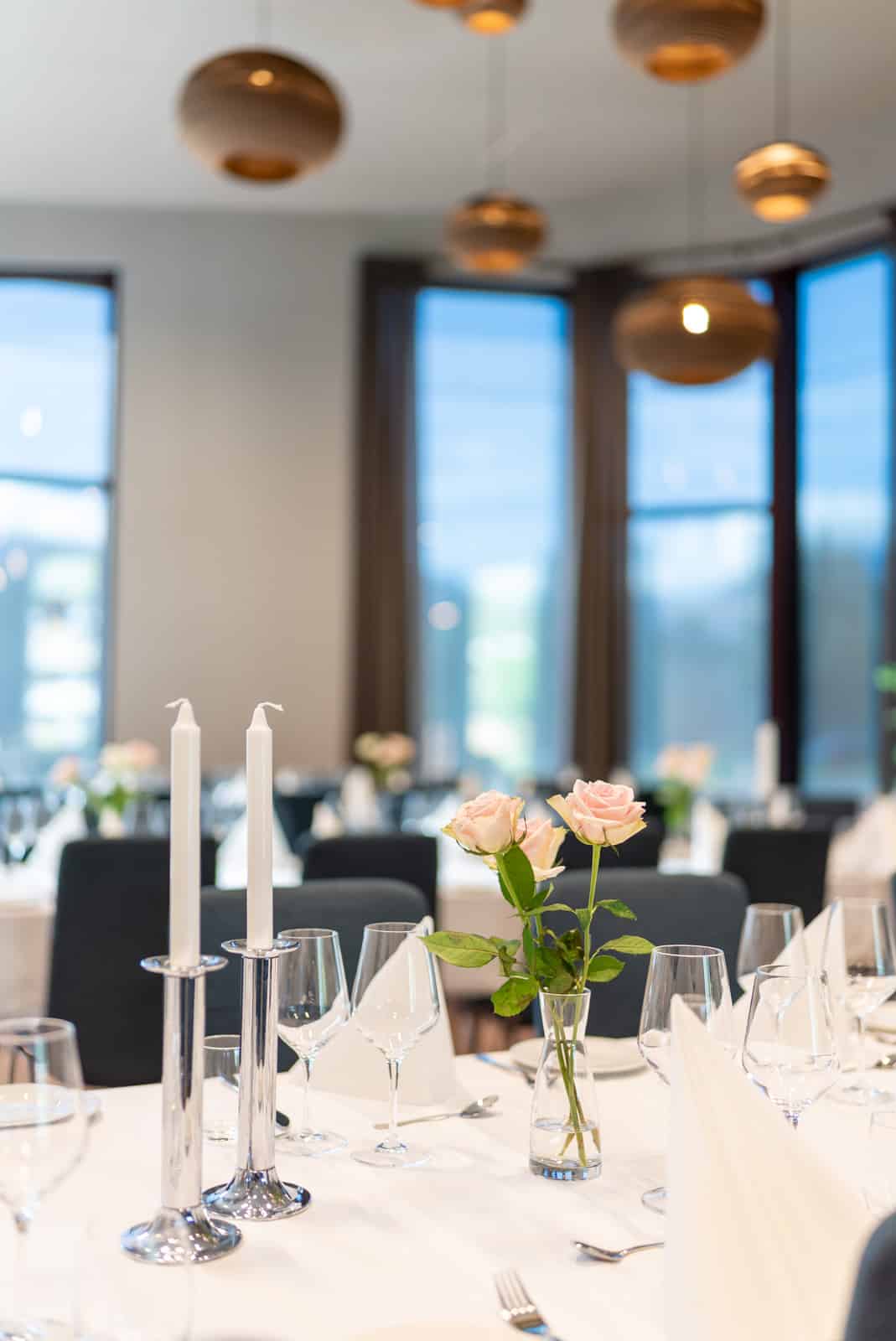 Set dining table with roses and candles in Valldal